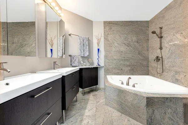 a bathroom with a large tub sink and mirror