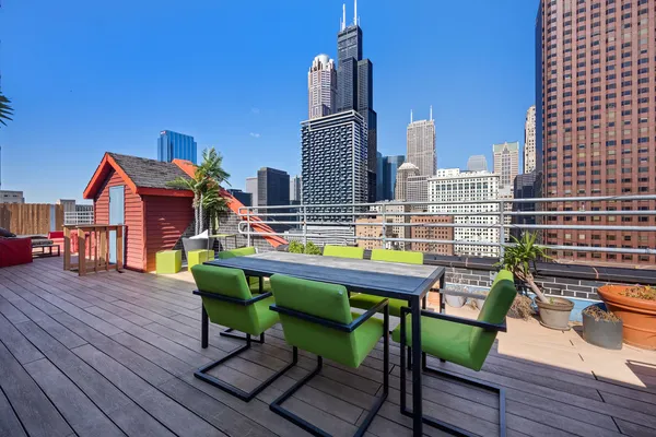 a view of a chairs and table on the wooden deck