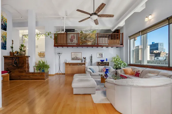 a living room with furniture and wooden floor
