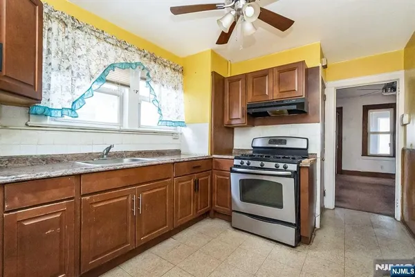 a kitchen with stainless steel appliances granite countertop a stove and a sink