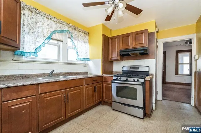 a kitchen with stainless steel appliances granite countertop a stove and a sink
