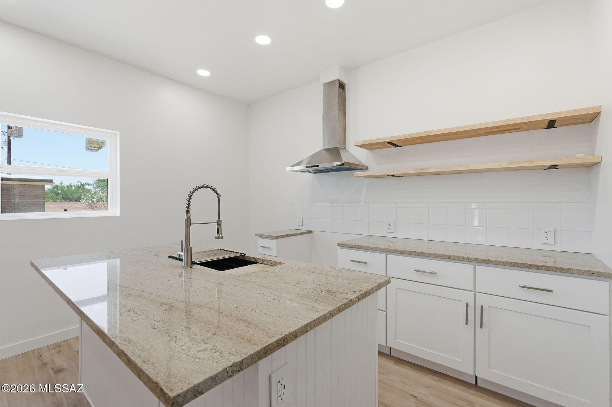 950 West Ina Road Tucson, AZ 85704 - Photo 39 of 54 a kitchen with a sink and white cabinets