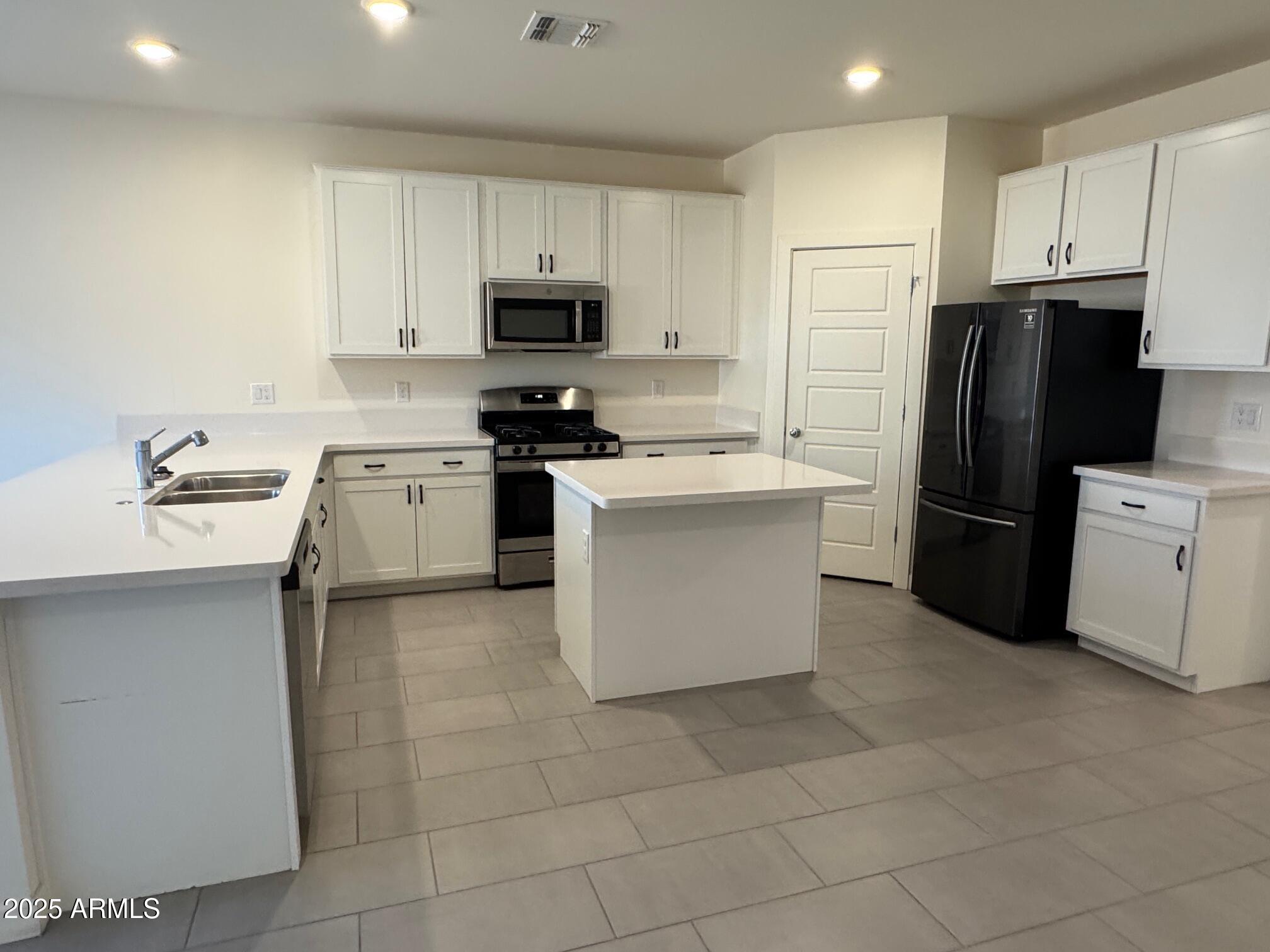 724 East Ruby Drive Casa Grande, AZ 85122 - Photo 11 of 20 a kitchen with cabinets stainless steel appliances and a counter space