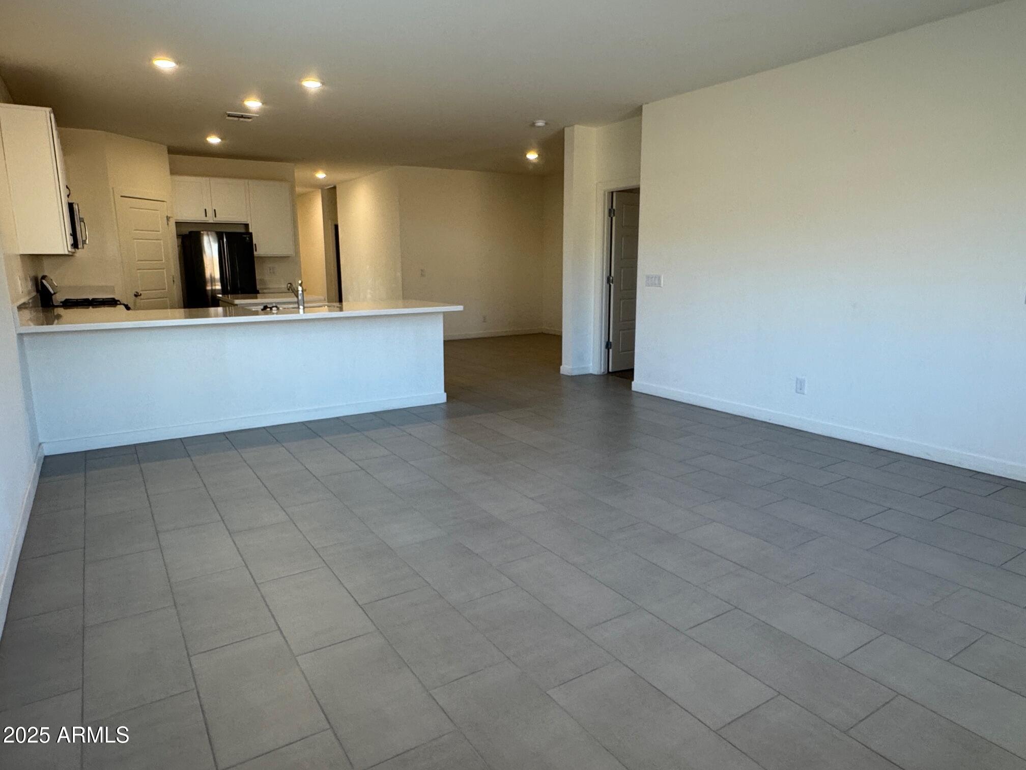 724 East Ruby Drive Casa Grande, AZ 85122 - Photo 12 of 20 a view of an empty room with kitchen