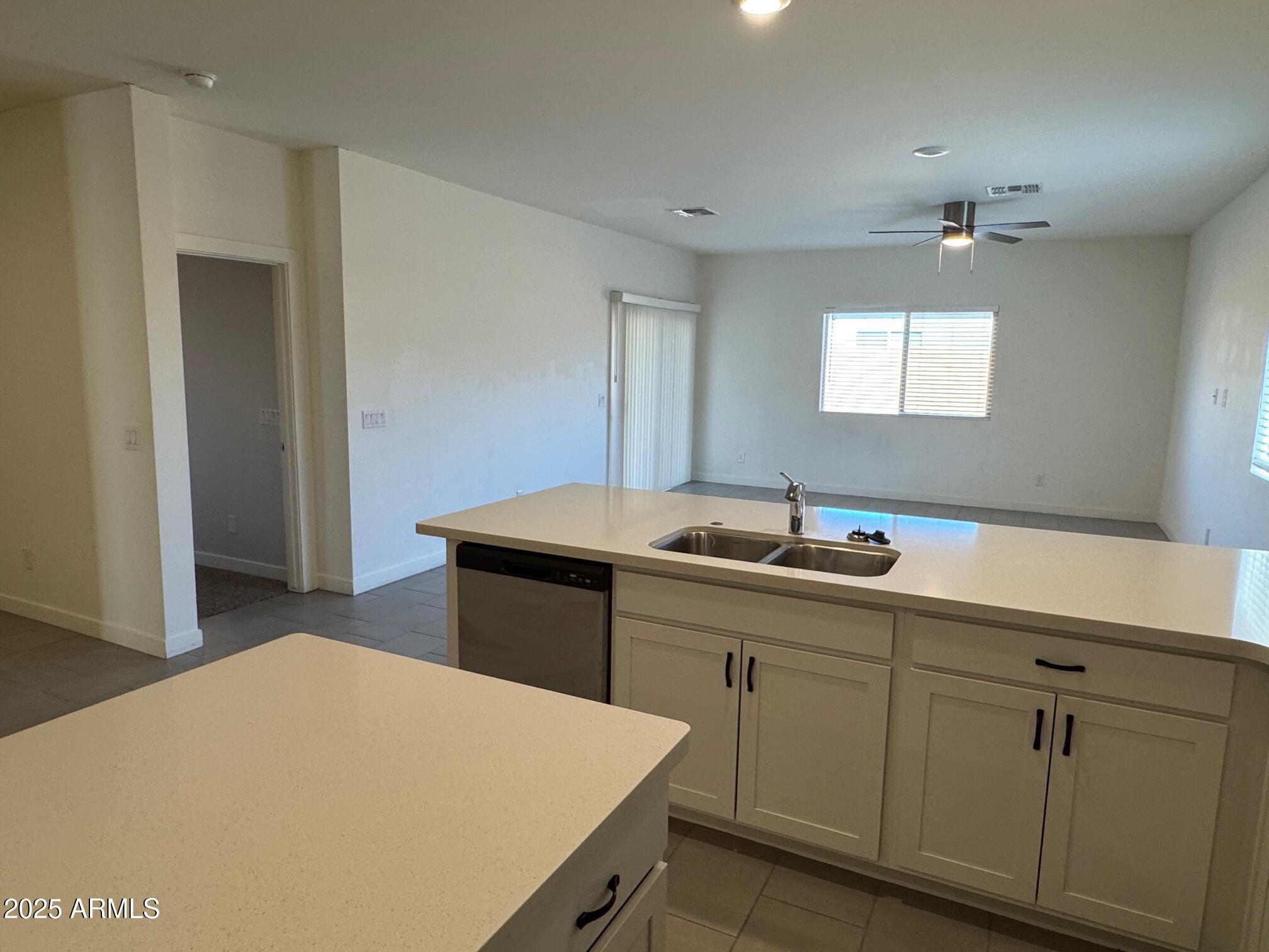 724 East Ruby Drive Casa Grande, AZ 85122 - Photo 13 of 20 a kitchen with a sink and wooden cabinets