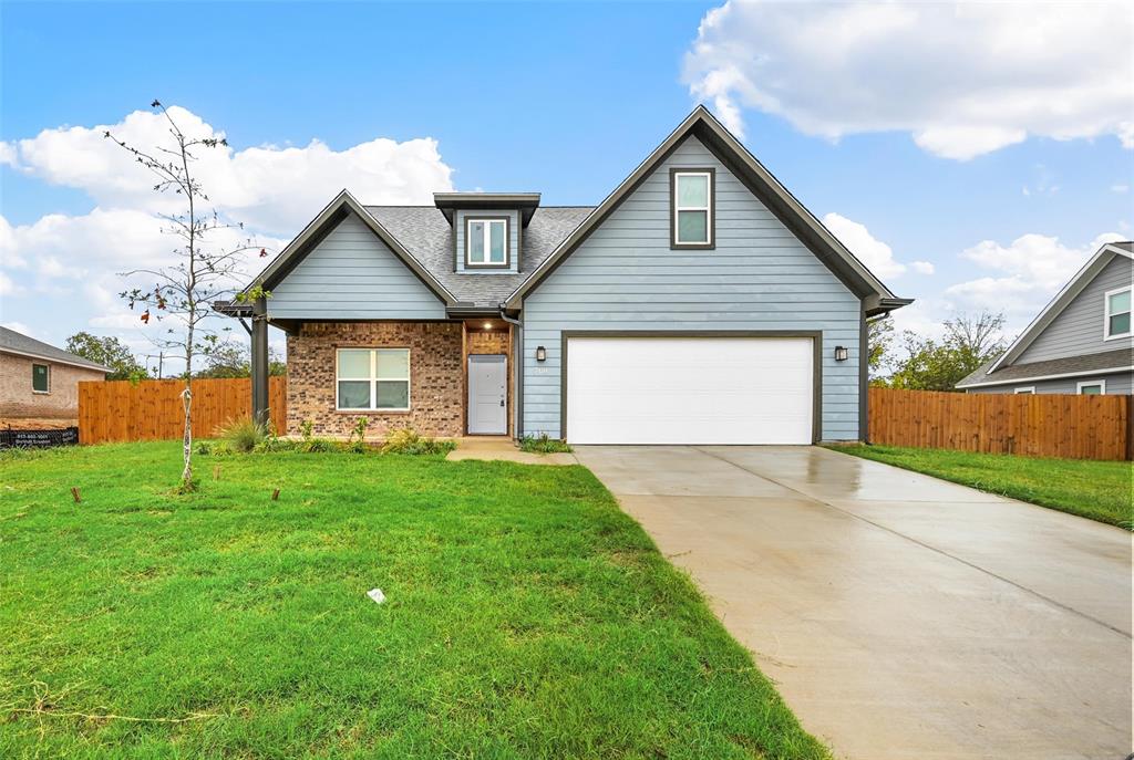 708 Porcupine Drive Springtown, TX 76082 - Photo 1 of 1 a front view of a house with a yard and garage