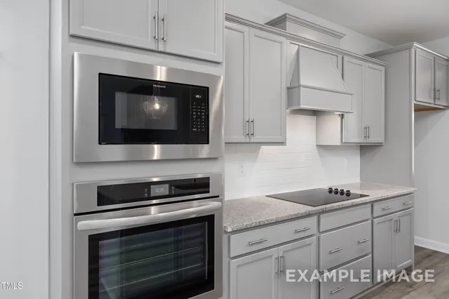 a kitchen with cabinets stainless steel appliances and a counter space