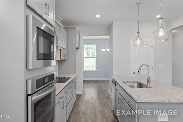 a kitchen with a sink stove and cabinets
