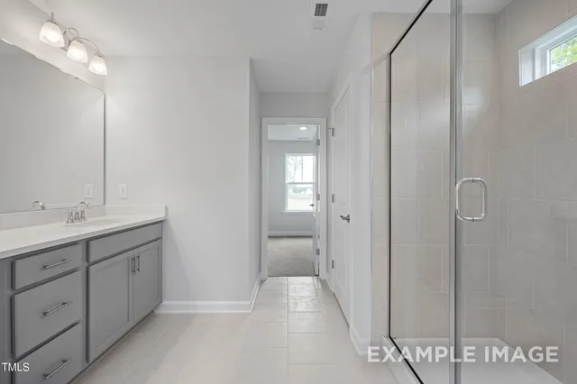 a bathroom with a double vanity sink and mirror