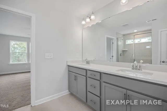 a bathroom with a double vanity sink and a mirror