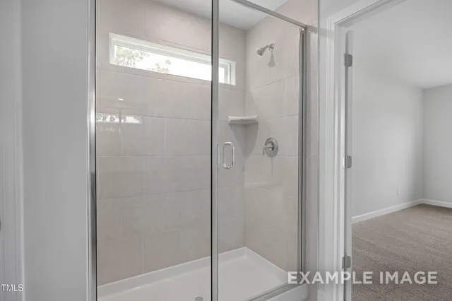 a bathroom with a glass shower door