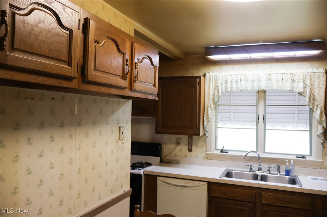 6637 Center Road Ashtabula, OH 44004 - Photo 29 of 44 Kitchen featuring sink and white appliances