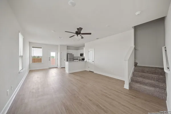 a view of empty room with wooden floor and window