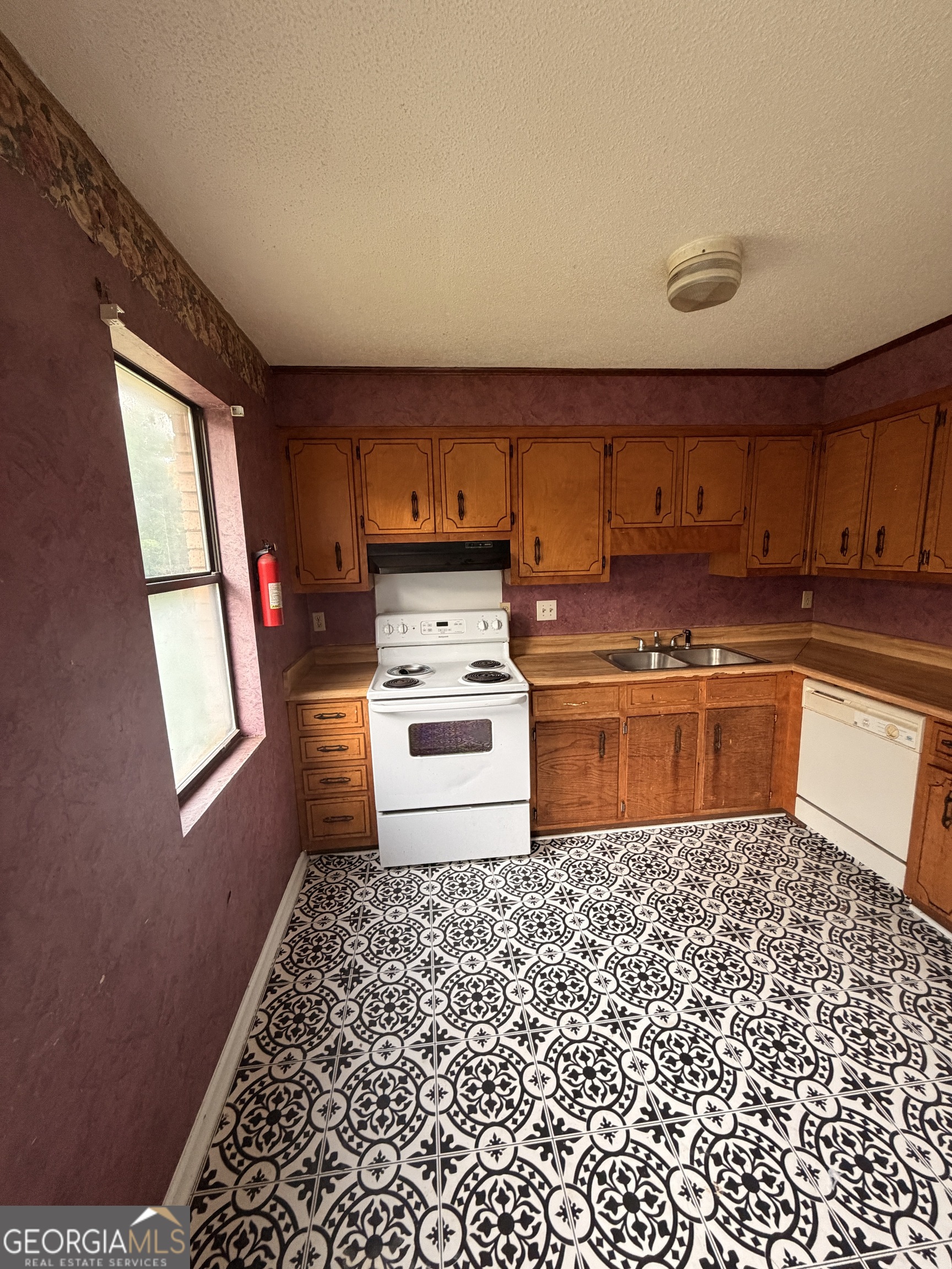 3523 Morgan Road Hephzibah, GA 30815 - Photo 5 of 15 a kitchen with a stove a sink and a microwave