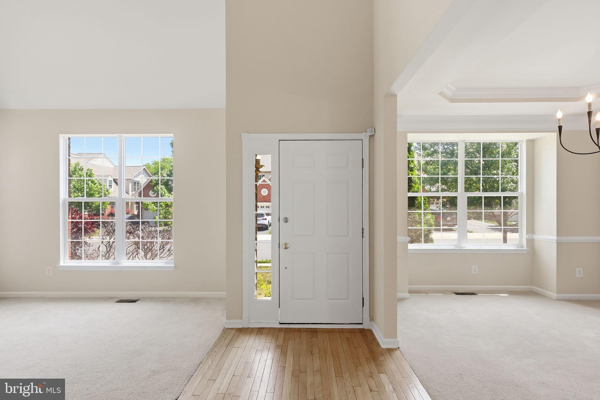19617 Edgemont Square Ashburn, VA 20147 - Photo 3 of 65 an empty room with wooden floor and windows