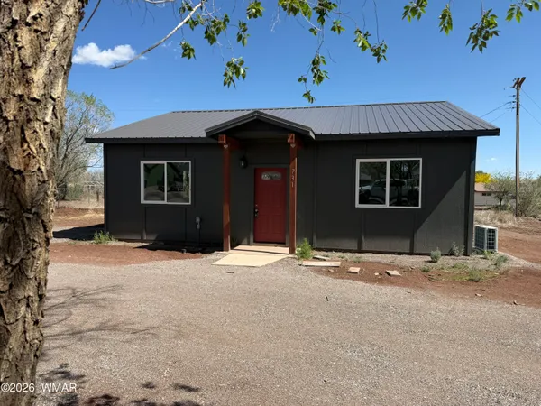 a kitchen with stainless steel appliances granite countertop a refrigerator a sink dishwasher a stove and white countertops with wooden floor