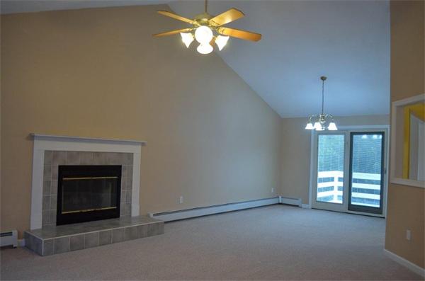 6 Clover Hill Road Sutton, MA 01590 - Photo 8 of 23 a view of an empty room with chandelier fan and fire place