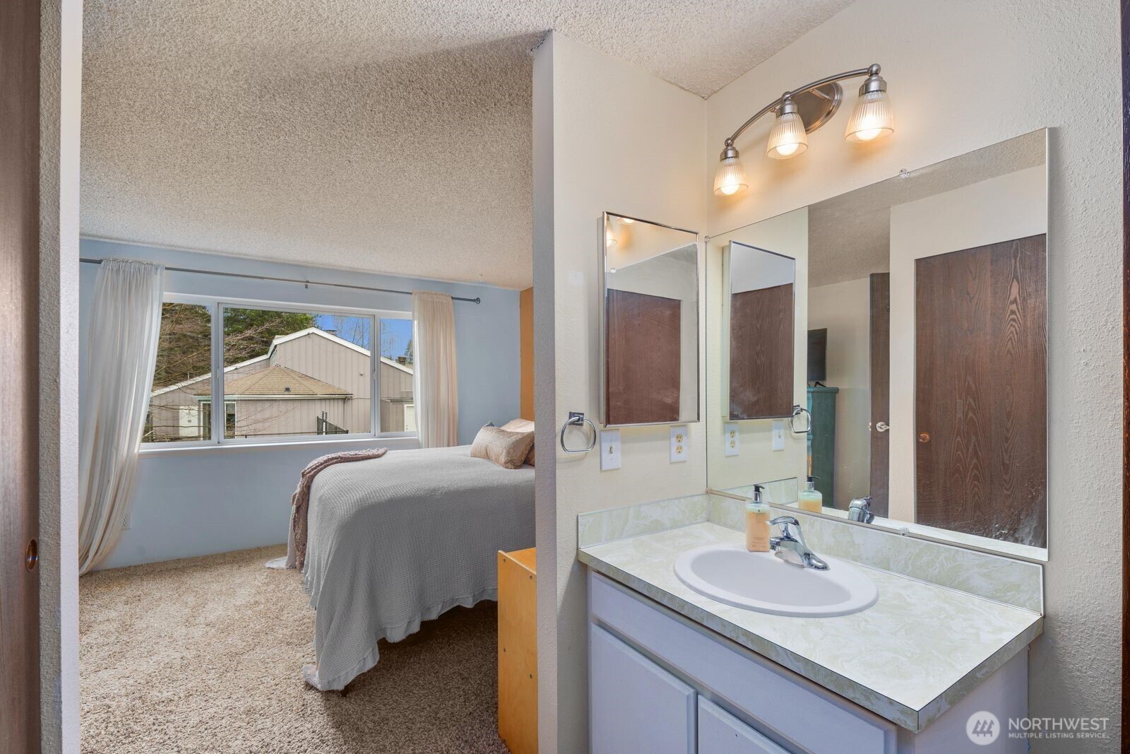 3114 Southwest 319th Place, Unit 45 Federal Way, WA 98023 - Photo 19 of 39 a en suite bathroom with a sink and a mirror