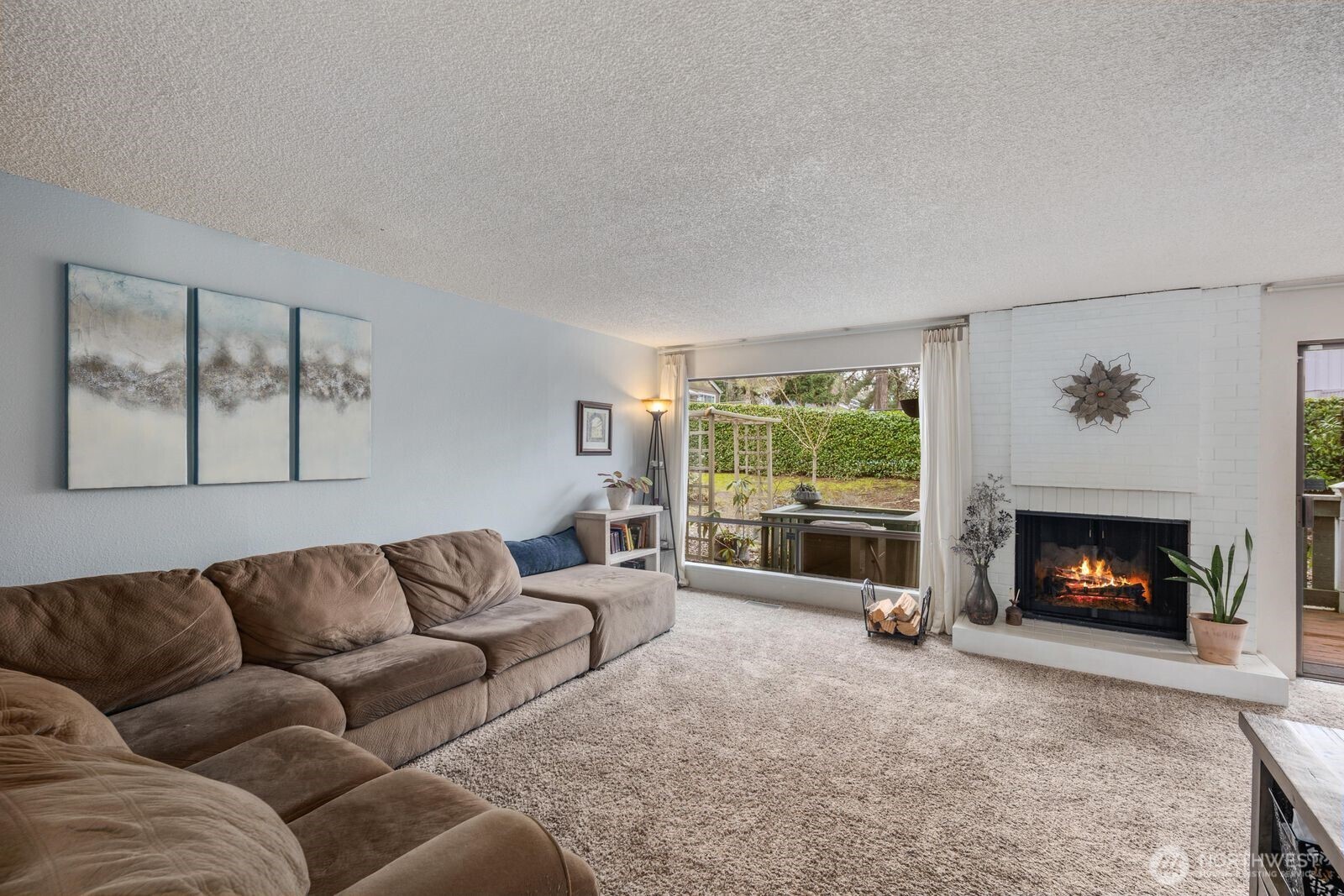 3114 Southwest 319th Place, Unit 45 Federal Way, WA 98023 - Photo 5 of 39 a living room with furniture a flat screen tv and a fireplace
