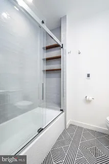 a bathroom with a bathtub and a shower