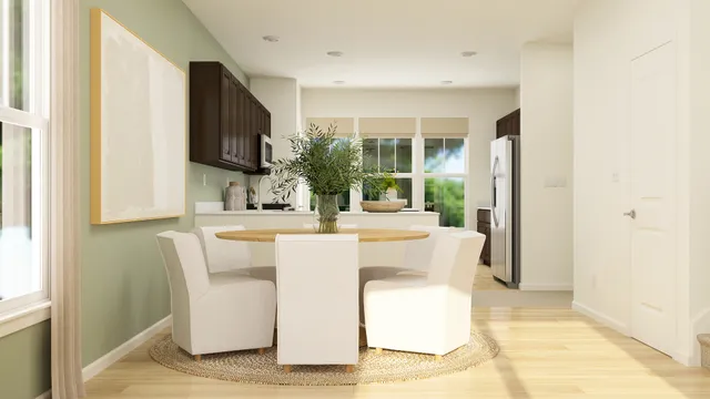 a dining room with kitchen island stainless steel appliances furniture a window and a kitchen view