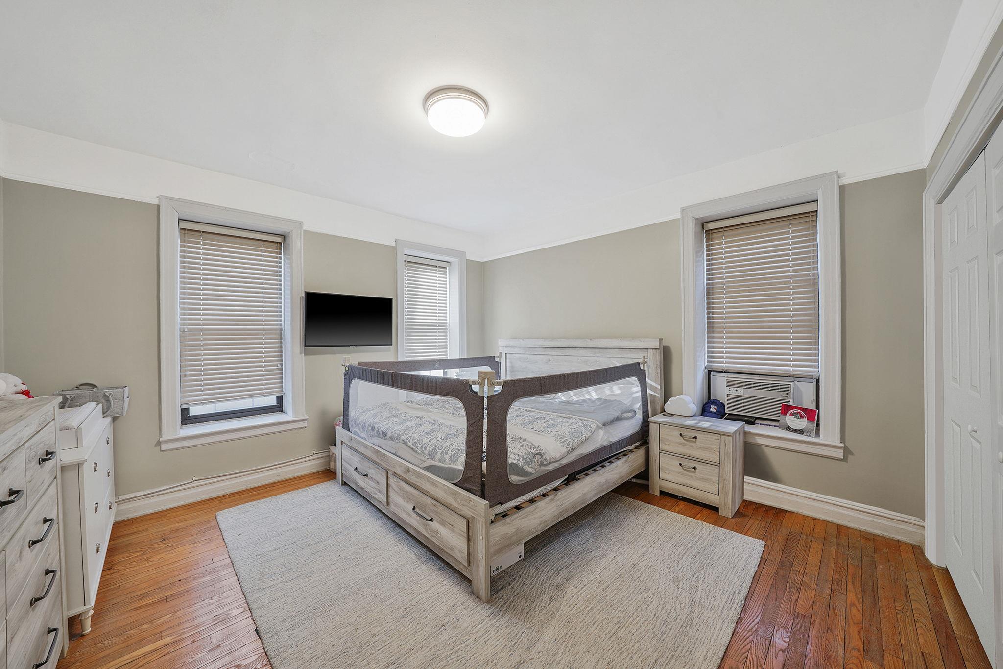 83-84 116th Street, Unit 1H Queens, NY 11418 - Photo 5 of 13 a bedroom with a bed and a window