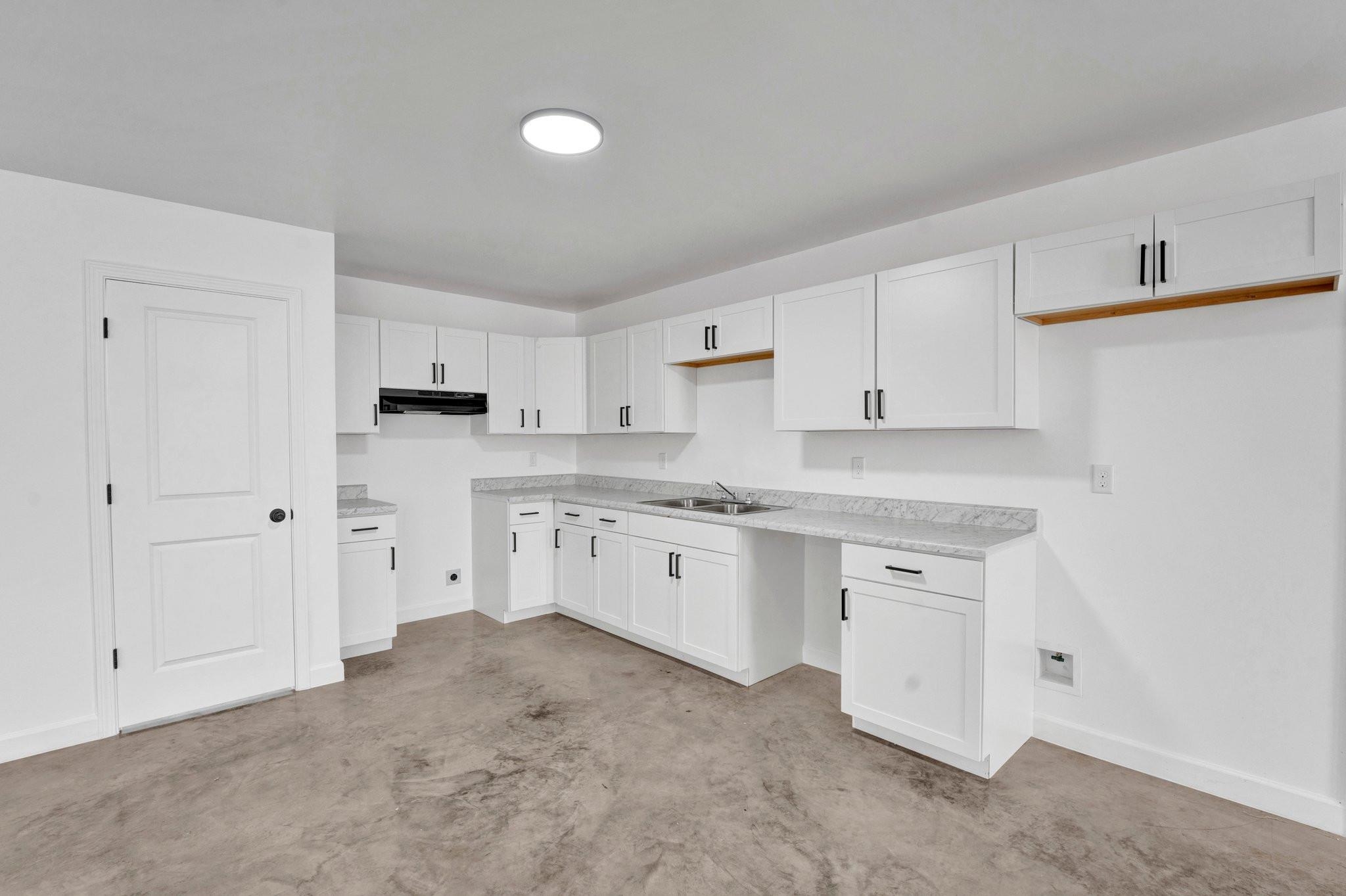 630 King Road Memphis, TN 38109 - Photo 6 of 27 Kitchen featuring sink and white cabinetry