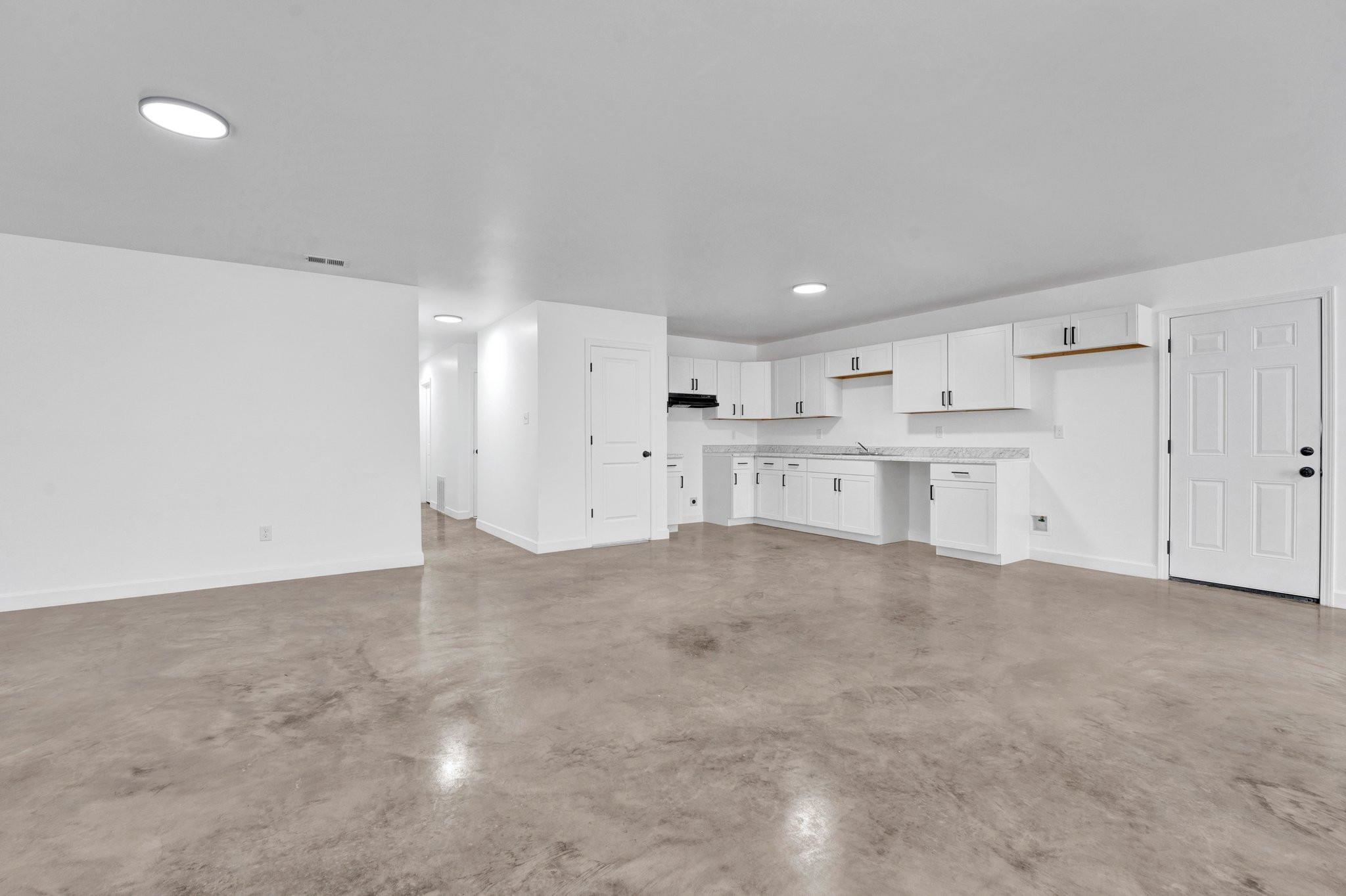 630 King Road Memphis, TN 38109 - Photo 7 of 27 Unfurnished living room featuring concrete flooring