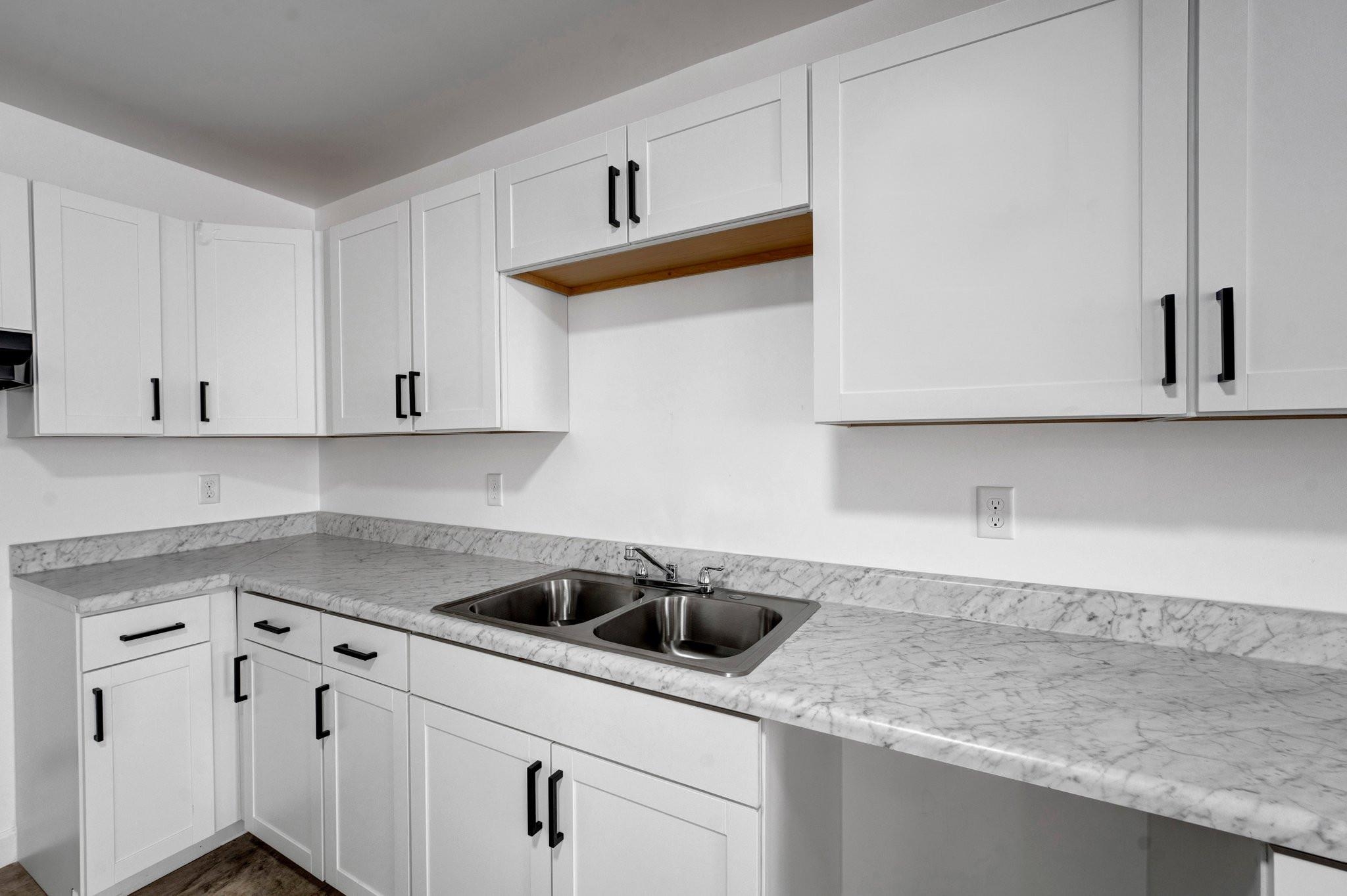 630 King Road Memphis, TN 38109 - Photo 8 of 27 Kitchen with sink, white cabinetry, and light stone countertops