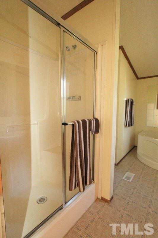 350 Big Pine Road Clayton, NC 27520 - Photo 11 of 20 a view of a bathroom with a glass door shower