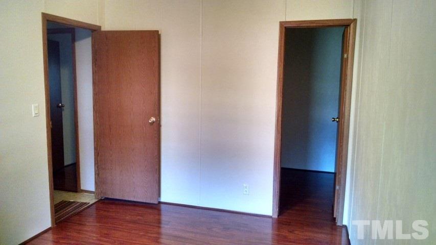 350 Big Pine Road Clayton, NC 27520 - Photo 14 of 20 an empty room with wooden floor