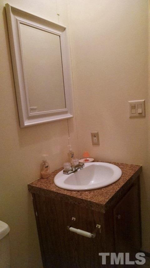 350 Big Pine Road Clayton, NC 27520 - Photo 16 of 20 a bathroom with a sink and a mirror