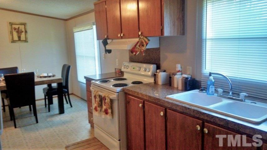350 Big Pine Road Clayton, NC 27520 - Photo 3 of 20 a kitchen with a sink stove and cabinets