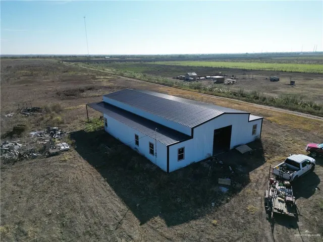 a view of a terrace with lawn chairs