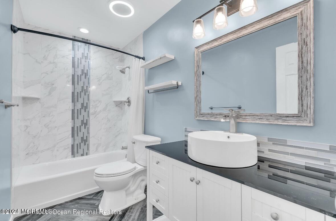 1002 Sawmill Road Brick, NJ 08724 - Photo 16 of 27 a bathroom with a sink toilet and shower