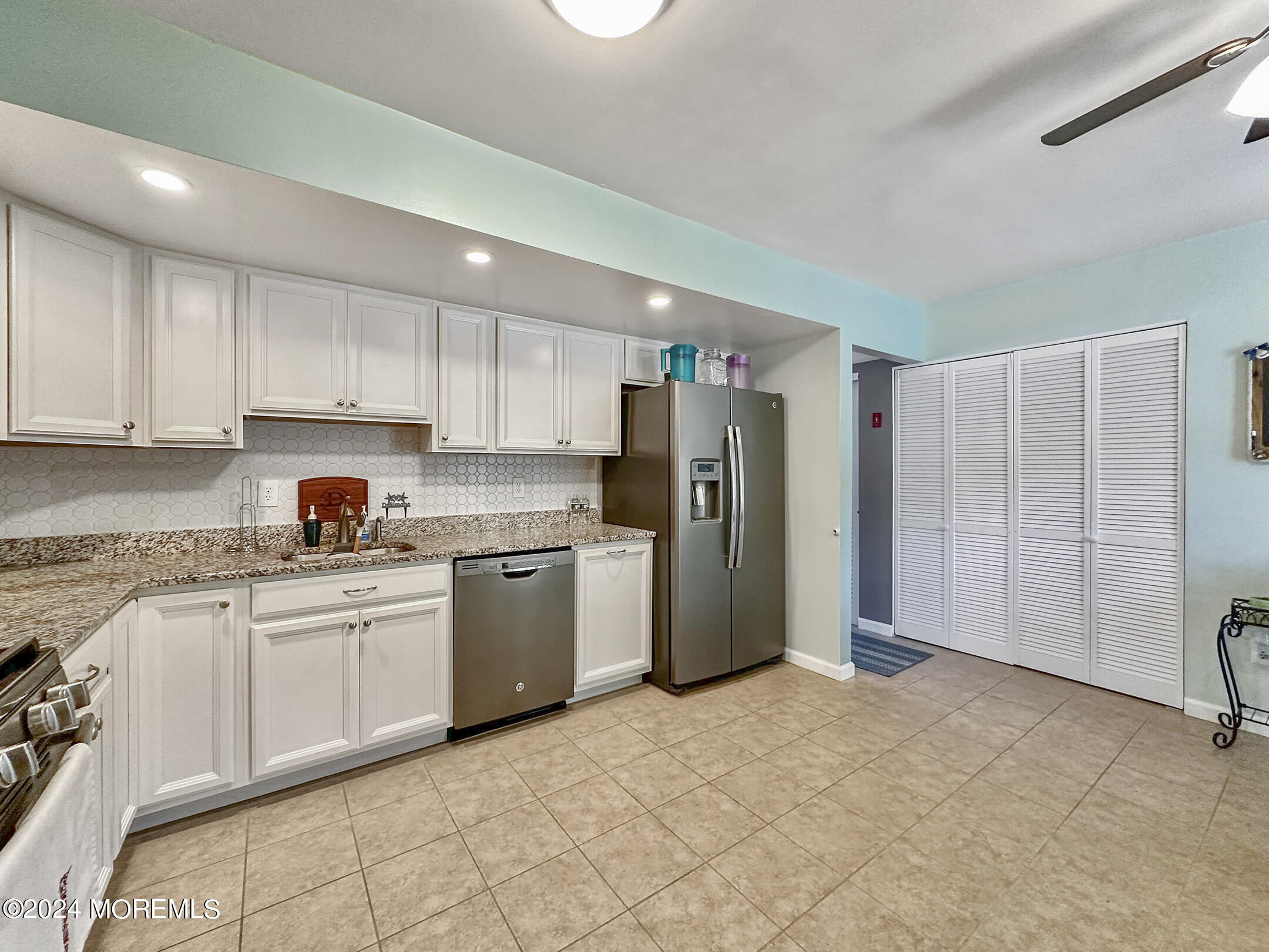 1002 Sawmill Road Brick, NJ 08724 - Photo 10 of 27 a kitchen with a refrigerator sink and cabinets