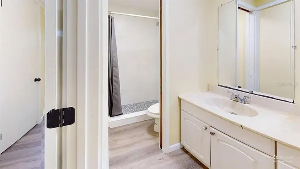 a spacious bathroom with a shower and a sink