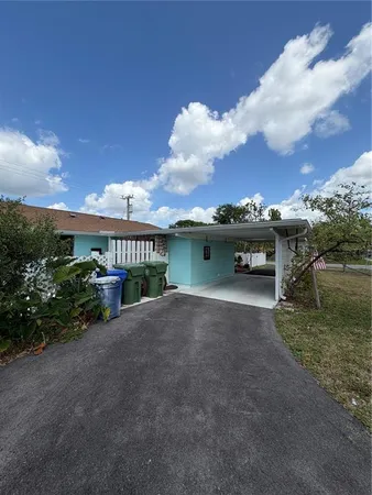 a view of a house with a yard and sitting area