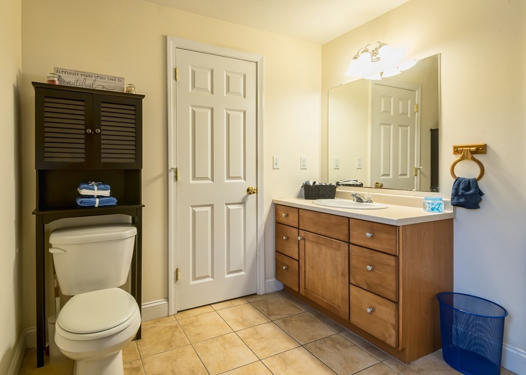 263 Forest Street Methuen, MA 01844 - Photo 12 of 18 a bathroom with a toilet a sink and mirror