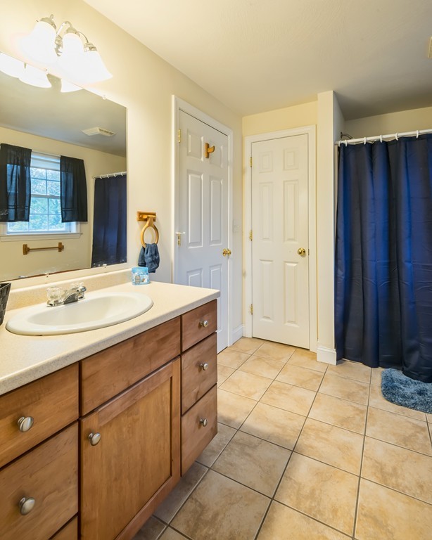 263 Forest Street Methuen, MA 01844 - Photo 13 of 18 a bathroom with a sink a vanity and a mirror