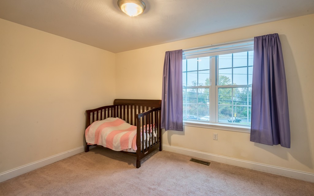 263 Forest Street Methuen, MA 01844 - Photo 16 of 18 a view of a bedroom with a bed and a window