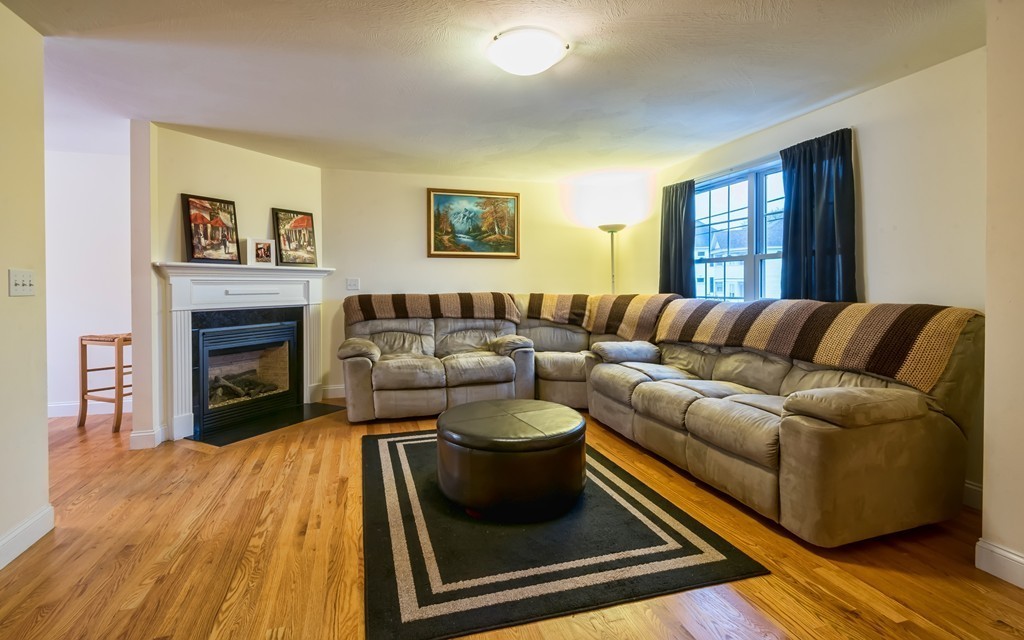 263 Forest Street Methuen, MA 01844 - Photo 2 of 18 a living room with a couch and a fireplace