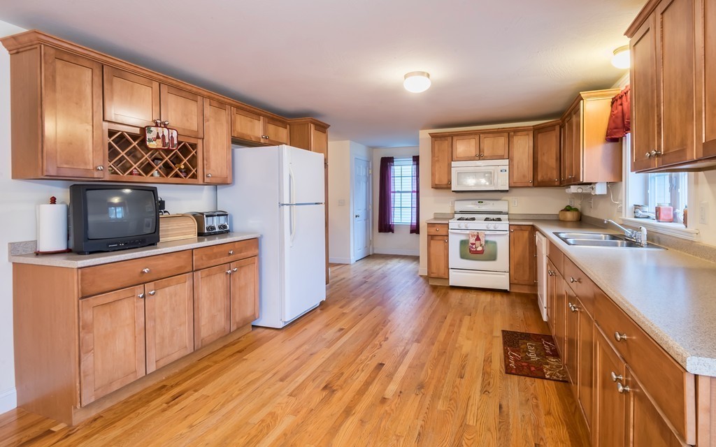 263 Forest Street Methuen, MA 01844 - Photo 4 of 18 a kitchen with stainless steel appliances a stove a sink a refrigerator and cabinets