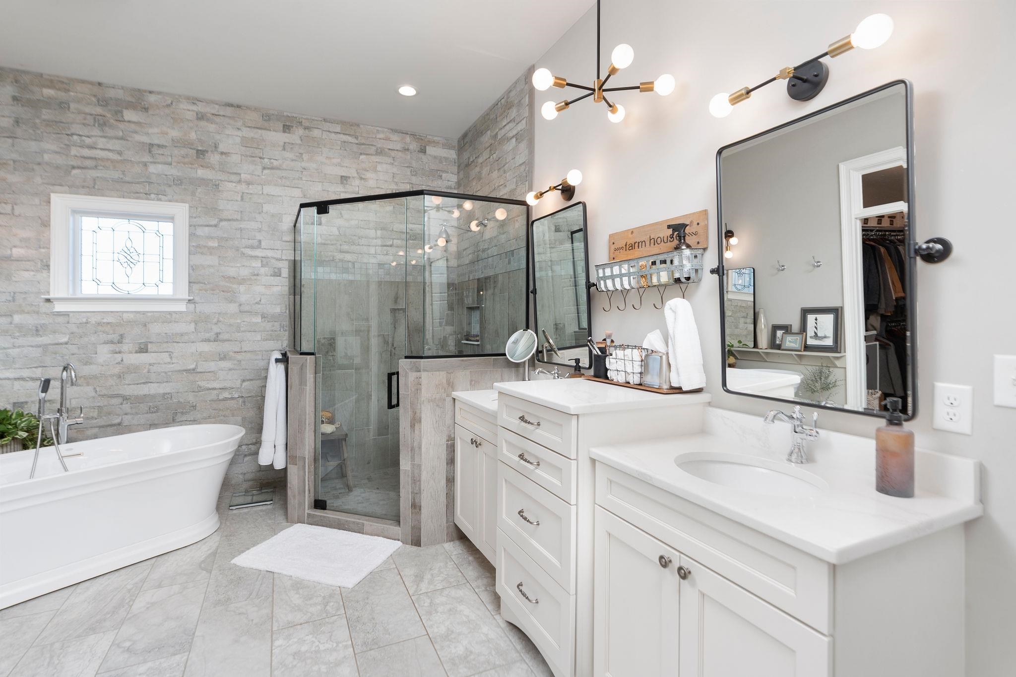 10 Cora Lane Lexington, VA 24450 - Photo 32 of 74 a spacious bathroom with a double vanity sink a mirror a bathtub and a shower