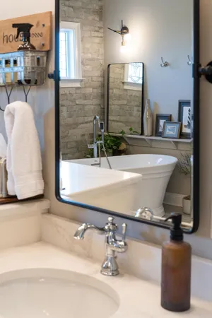 a bathroom with a toilet sink and mirror