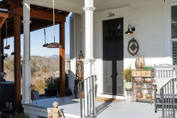 a living room with furniture kitchen view and a chandelier