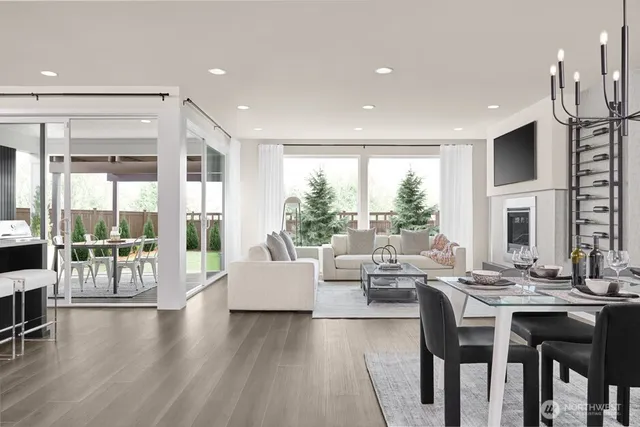 a living room with furniture a fireplace and a large window