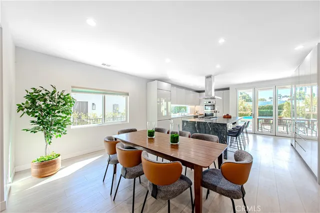 a dining room with furniture and wooden floor