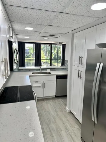 a kitchen with a refrigerator a sink and dishwasher