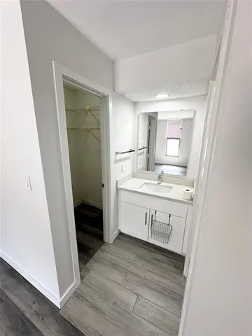 a bathroom with a sink a mirror and a shower